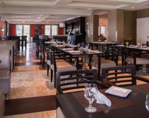 a dining room with tables and chairs in a restaurant at Doral 2-Story Villa 3 Bed 4 Bath at Provident Doral at The Blue Miami in Miami