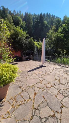 a surfboard sitting on top of a stone patio at Ferienwohnungen BergArt in Iselsberg