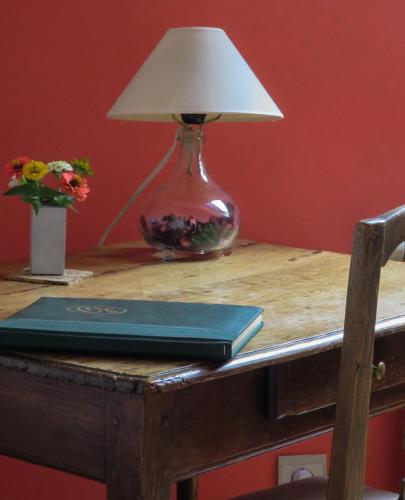 a lamp sitting on top of a table with a book at B&B Woluwé in Brussels