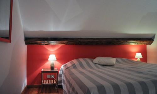 a bedroom with a bed with a red wall at B&B Woluwé in Brussels