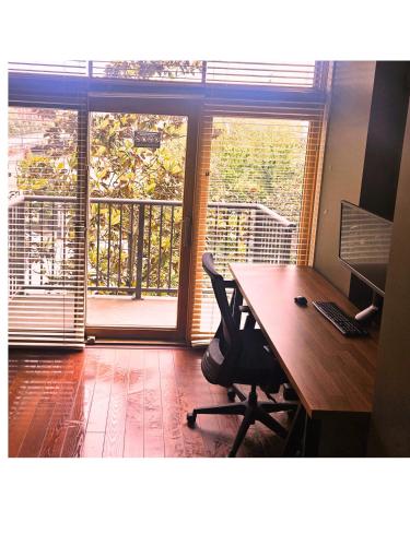 an office with a desk with a computer and a balcony at Renu Suites at The Burlington Portland in Portland