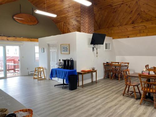 a living room with wooden ceilings and tables and chairs at Canadas Best Value Inn & Suites Summerside in Summerside