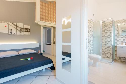 a bedroom with a bed and a bathroom at Unplug in Quartu SantʼElena
