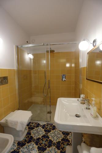 a bathroom with a shower and a sink and a toilet at Casa Cuseni, Patrimonio Culturale Immateriale UNESCO in Taormina
