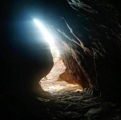 a dark cave with the light at the end of it at La Grotta di benikula' in Pantelleria