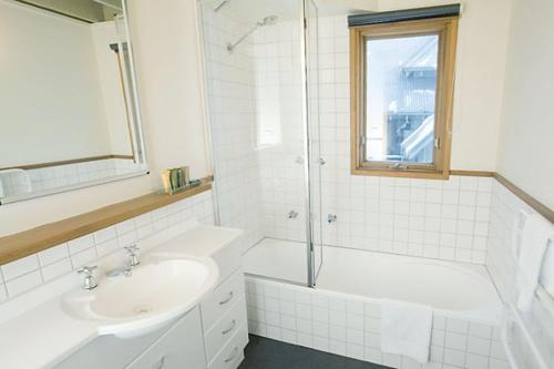 a bathroom with a sink and a shower and a tub at Eagles Nest in Mount Hotham