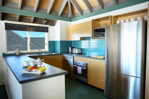 a kitchen with a stainless steel refrigerator in it at Gotcha in Mount Hotham