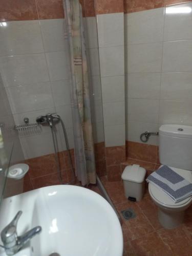 a bathroom with a sink and a toilet at Hotel Tainaro in Loutra Edipsou