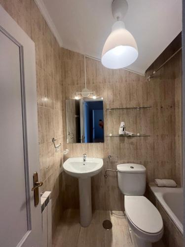 a bathroom with a toilet and a sink and a mirror at Mies de Prado in Comillas