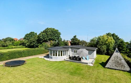 a small house in the middle of a yard at Nice Home In Roslev With Wifi in Roslev
