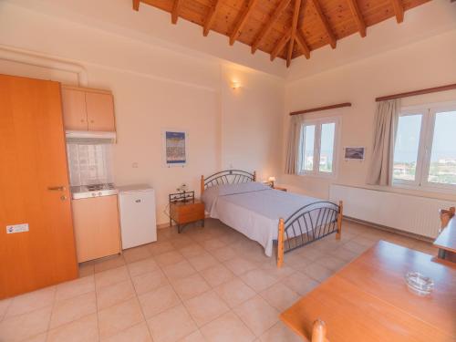a large bedroom with a bed and a kitchen at Apartments Hotel & Studios, Xifoupolis in Monemvasia