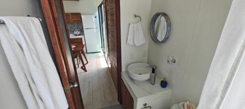 a bathroom with a toilet and a sink in it at Tu Departamento en Mahahual in Mahahual