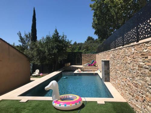 - une piscine avec un flotteur de cygnes dans une cour dans l'établissement Villa avec piscine et place de parking proche centre ville, à Aix-en-Provence