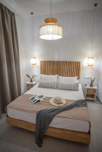 a bedroom with a large bed with a hat on it at Panoramic View in Agios Prokopios