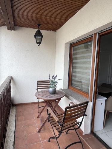 a patio with a table and chairs on a balcony at AppartHôtel Elite Spa in Forbach