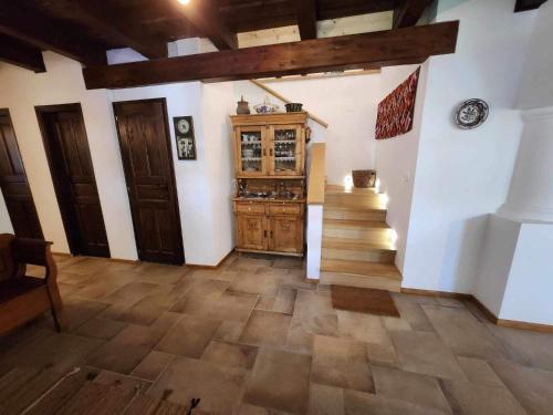 a room with a staircase and a wooden cabinet at A nyugalom háza in Szentbékkálla
