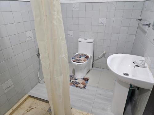 a bathroom with a toilet and a sink at Hills Kandy Apartment in Kandy