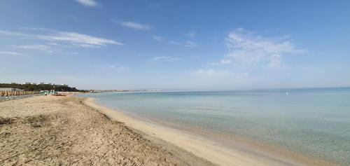 a sandy beach with the ocean in the background at Salento31 in Collepasso