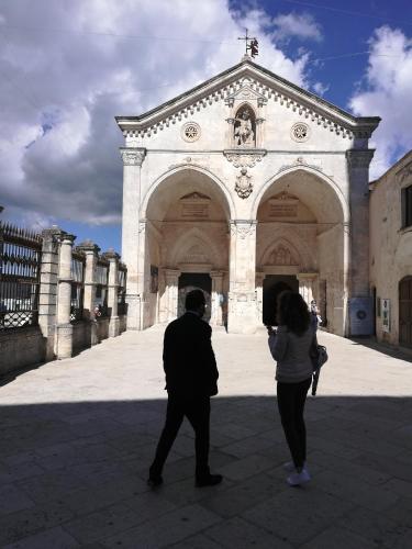 a man and a woman standing in front of a building at B&B Palazzo de Matteis in San Severo