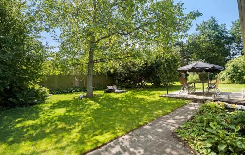 a garden with a gazebo and a picnic table at Amazing Home In Højby With Wifi in Højby