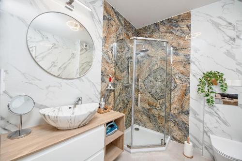 a bathroom with a sink and a shower at Poznań Grunwald - Parking & Terrace - by Rentujemy in Poznań