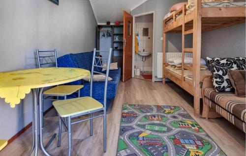 a room with a table and chairs and a bunk bed at 1 Bedroom Stunning Home In Rekowo in Rekowo