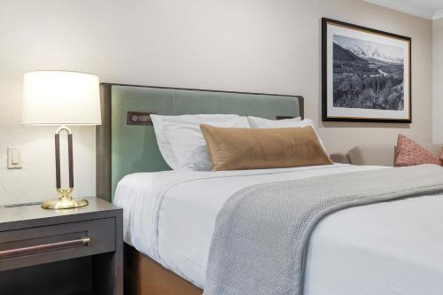 a hotel room with two beds and a lamp at The Lodge at Jackson Hole in Jackson