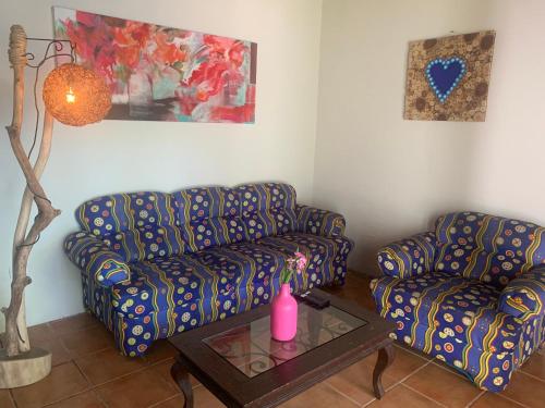 a living room with two couches and a table at Casa CARIBE Cancun in Cancún