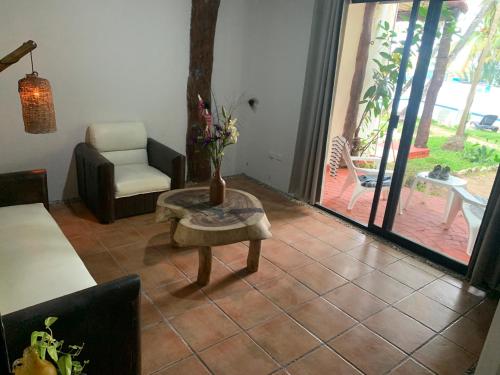 a living room with a couch and a chair and a table at Casa CARIBE Cancun in Cancún