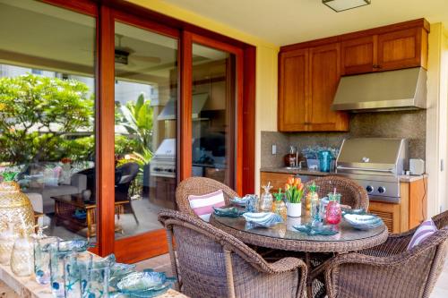 a table in a kitchen with chairs and a tableablish at Hilton Pool Pass Included, Kolea - Stylish & Comfy Walk to Beach Patio Pool Gym in Waikoloa