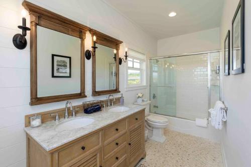 a bathroom with two sinks and a shower and a toilet at NEW - 7BD Farmhouse Estate - AC Pool Slide Gym Pickleball in Koloa