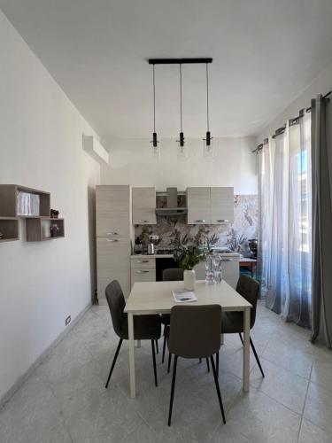 a kitchen and dining room with a table and chairs at Port House in Civitavecchia