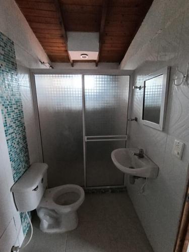 a bathroom with a toilet and a sink at Hostal Brisa y Mar in Arboletes