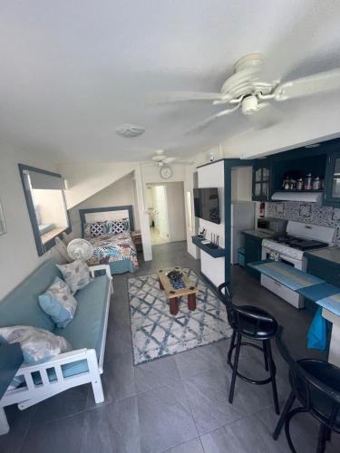 a living room with a couch and a table at Scarlett Studios 3-US Embassy 7 mins drive- Lloyd Erskine Sandiford Centre & Ross university 5 mins drive-Only a 1 night reservation includes airport and embassy round trip in Bridgetown