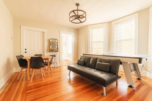 a living room with a piano and a dining table at Walk to Downtown Salem with Arcade- Free Parking! in Salem