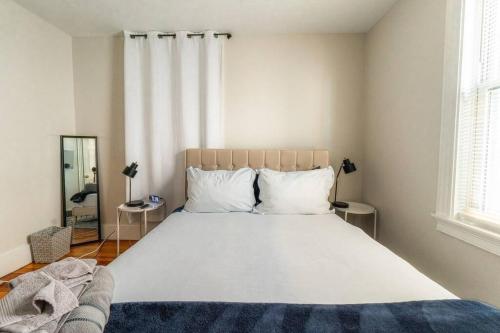 a bedroom with a large white bed with two pillows at Walk to Downtown Salem with Arcade- Free Parking! in Salem