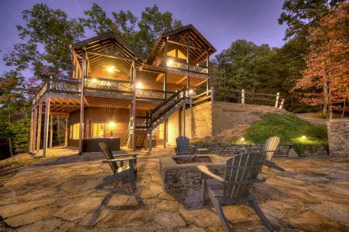 a house with two chairs sitting in front of it at View-Topia STUNNING VIEWS - Hot tub - Gameroom in Blue Ridge