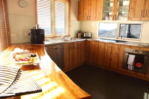 a kitchen with wooden cabinets and a wooden counter top at Sanki in Mount Hotham