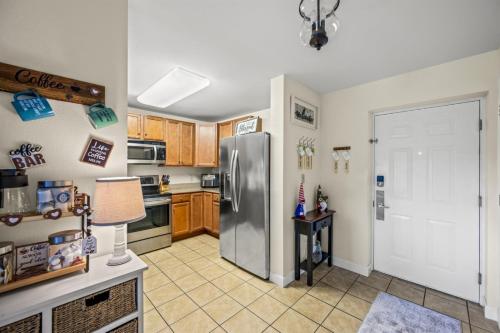 a kitchen with a stainless steel refrigerator at Smoky Mountain View Condo- Hot Tub, Indoor Pool, Walking Path, Playground in Pigeon Forge