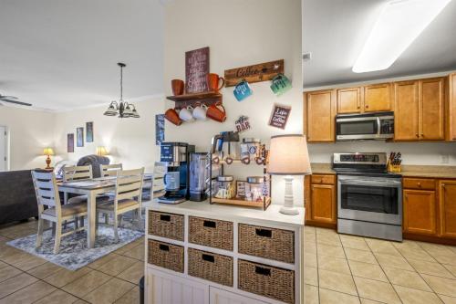 a kitchen with a table and a dining room at Smoky Mountain View Condo- Hot Tub, Indoor Pool, Walking Path, Playground in Pigeon Forge
