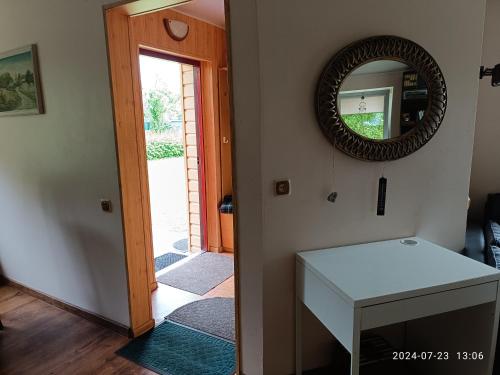 a hallway with a mirror and a white table at Nr.42 in Palanga