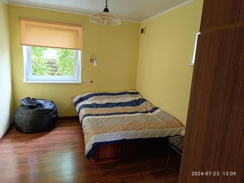 a bedroom with a bed in the corner of a room at Nr.42 in Palanga