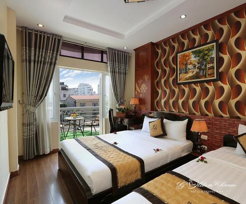 a hotel room with two beds and a balcony at Hanoi Golden Charm Hotel in Hanoi