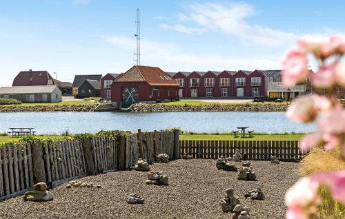 a bunch of birds sitting on the ground in front of a building at Stunning Home In Ulfborg With Wifi in Ulfborg