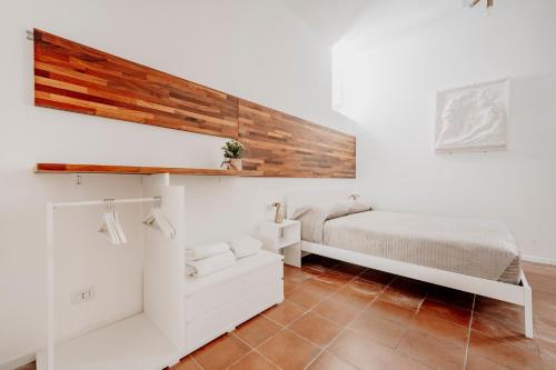 a bedroom with a bed and white walls at New Design Ortigia in Siracusa