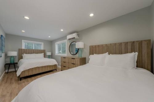 a large bedroom with two beds and a mirror at Sunset Family Villa C1 in Bridgman