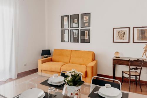 a living room with a couch and a table at New Design Ortigia in Siracusa
