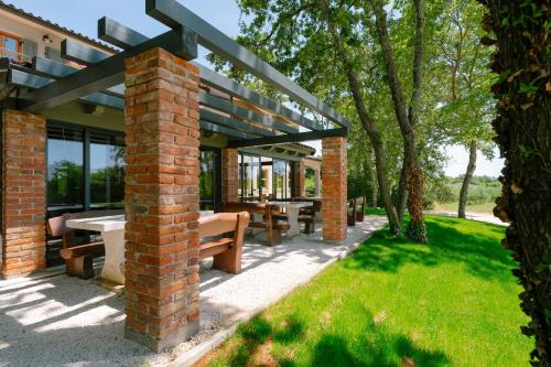 a pavilion with picnic tables and benches in a park at Boutique Hotel Paradiso in Poreč