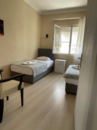 a small bedroom with two beds and a window at Almina Kantarcı Pansiyon in Ayvalık