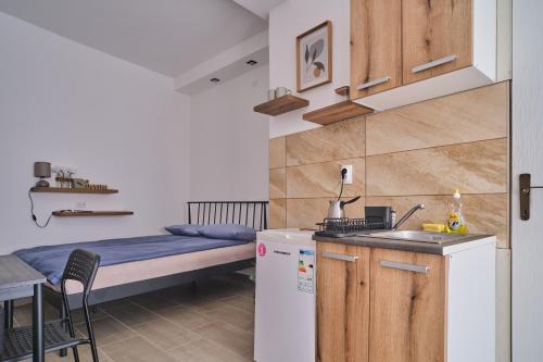 a small kitchen with a bed and a table at Studio Melem 2 in Soko Banja